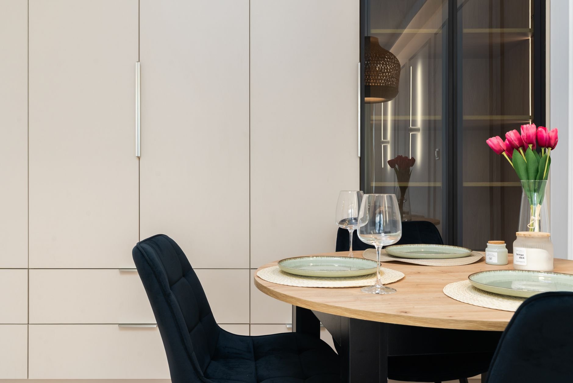 Stylish dining room with elegant tableware and decor, warm tones.